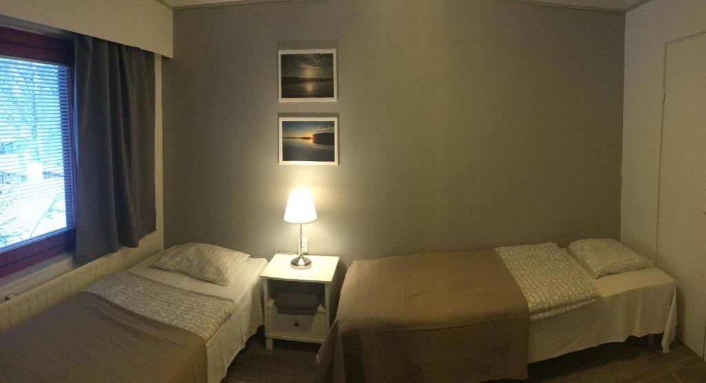 Postel nebo postele na pokoji v ubytování Guesthouse Borealis Apartments