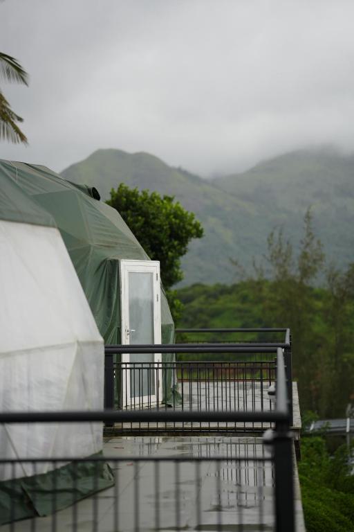 a tent on top of a house with mountains in the background at Dam View Glamps by SZ in Padinjarathara