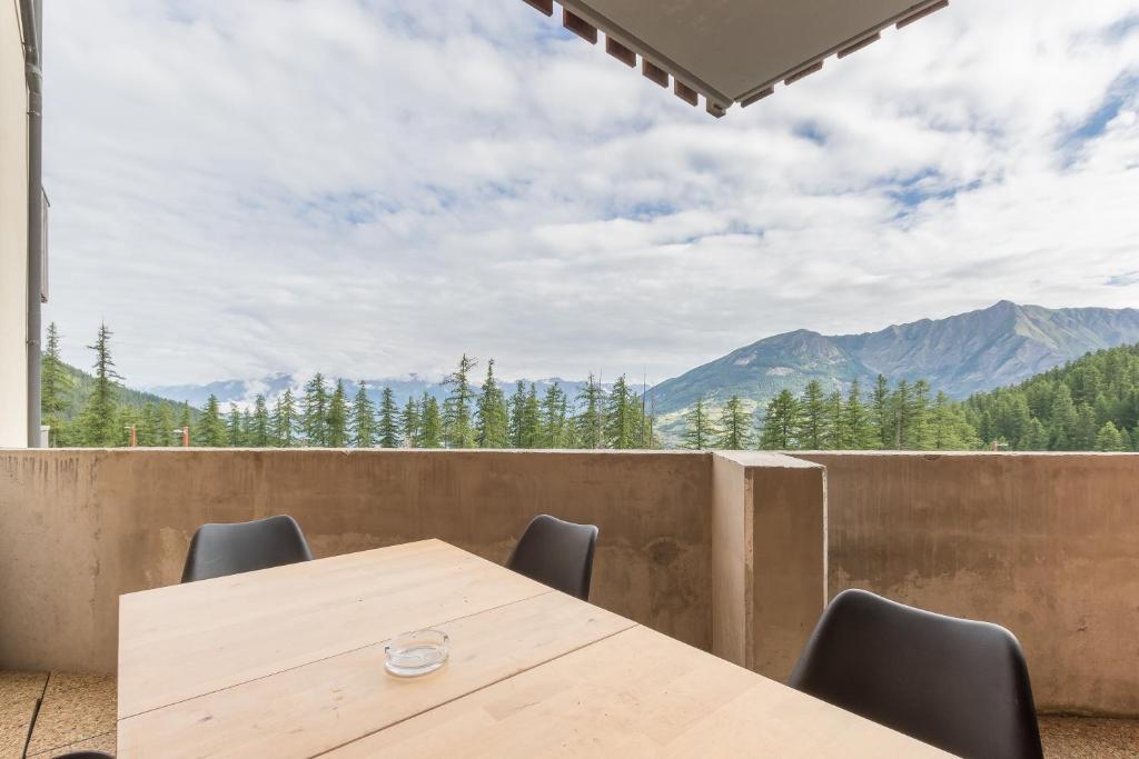 d'une table et de chaises avec vue sur les montagnes. dans l'établissement Les Mélèzes d'Or - Proche des pistes de ski, aux Orres