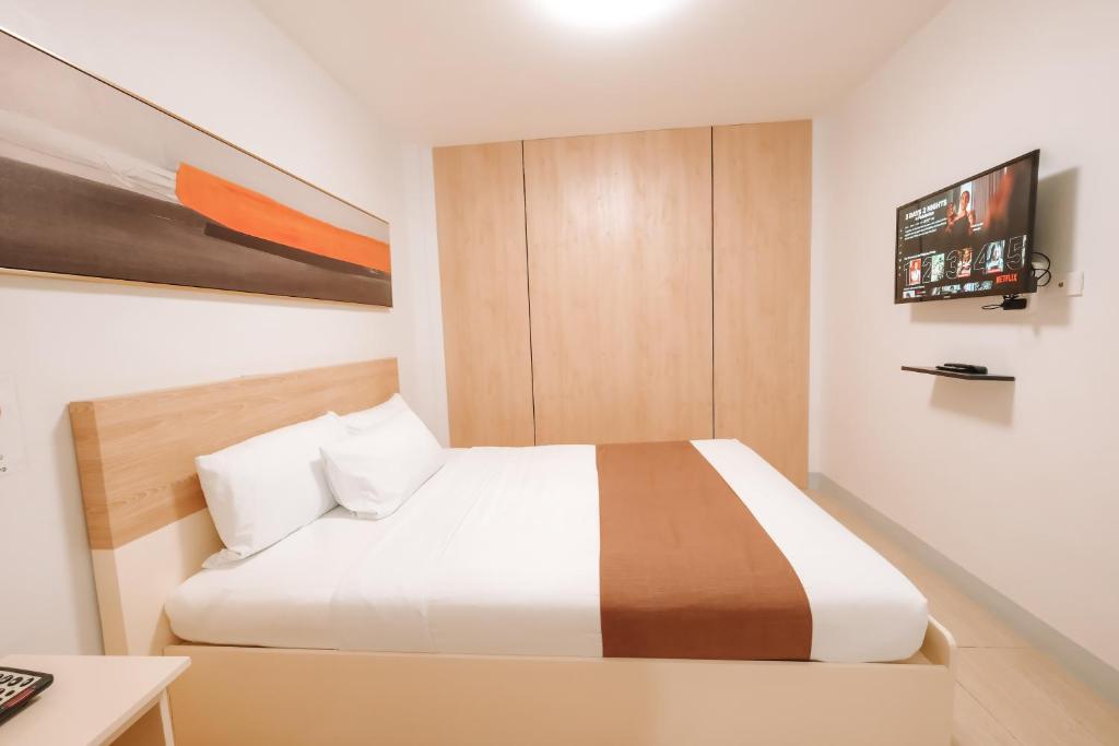 Postel nebo postele na pokoji v ubytování Rosey Hotel