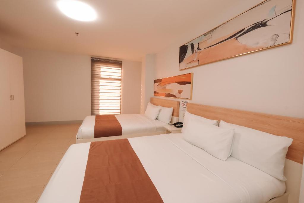 Postel nebo postele na pokoji v ubytování Rosey Hotel