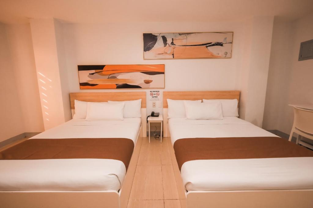 Postel nebo postele na pokoji v ubytování Rosey Hotel