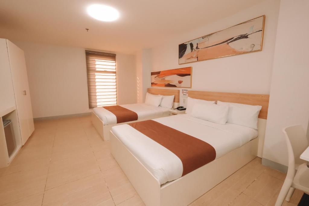 Postel nebo postele na pokoji v ubytování Rosey Hotel