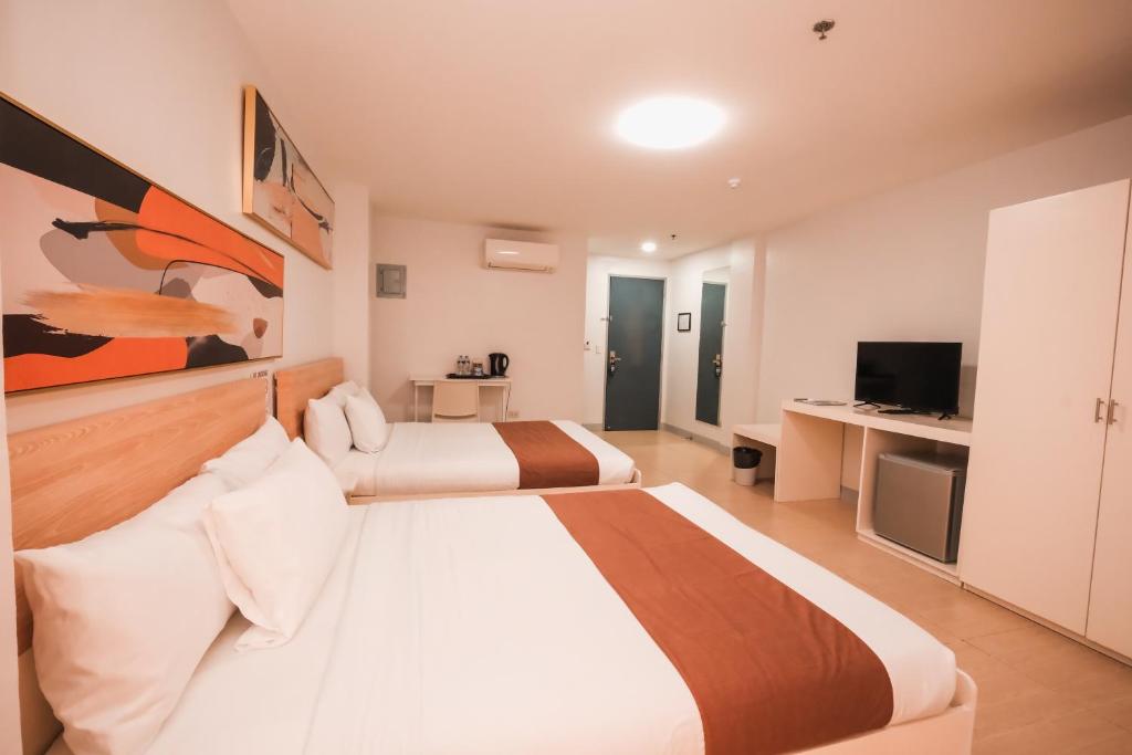 Postel nebo postele na pokoji v ubytování Rosey Hotel