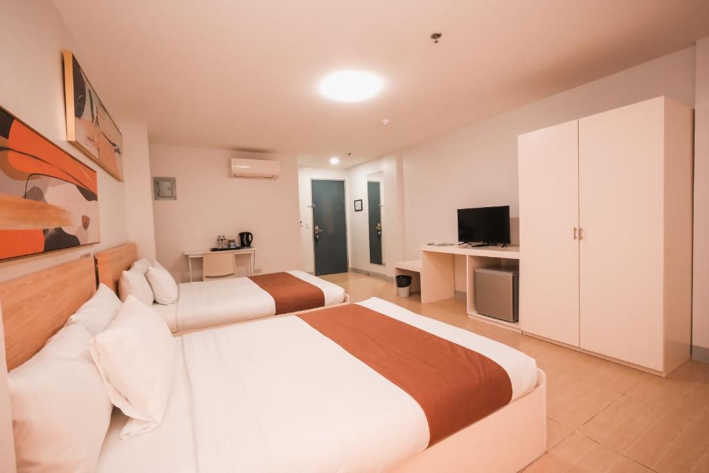 Postel nebo postele na pokoji v ubytování Rosey Hotel