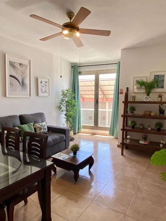 a living room with a couch and a ceiling fan at Casa Bubal by Best Holidays Fuerteventura in Corralejo