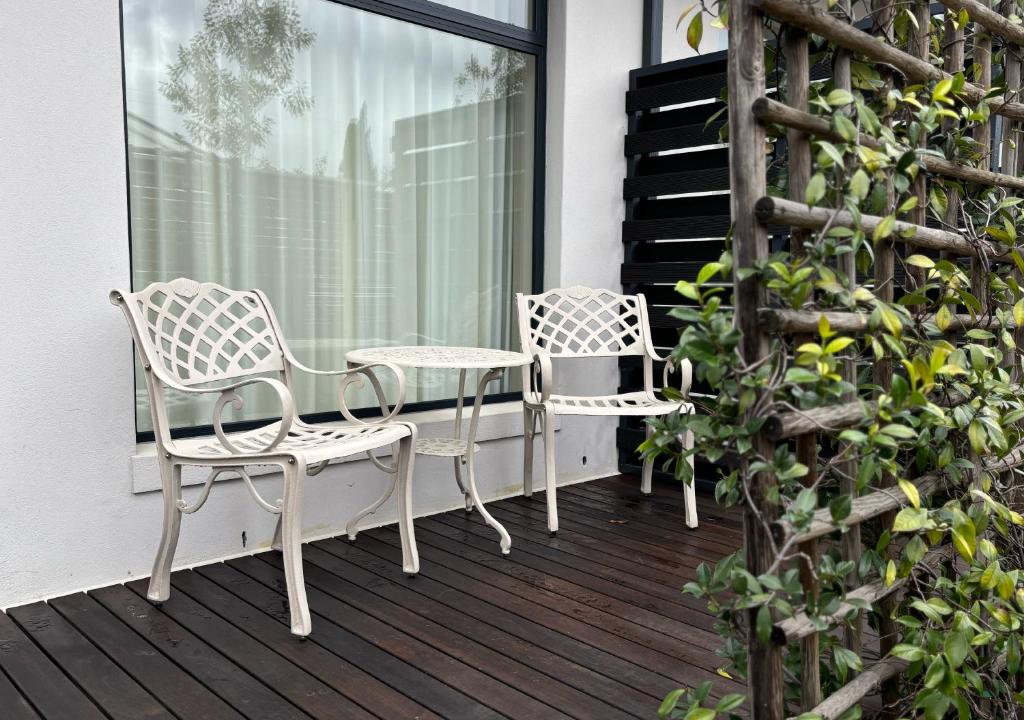 two chairs and a table on a balcony at Blix Inn Guesthouse in Stellenbosch