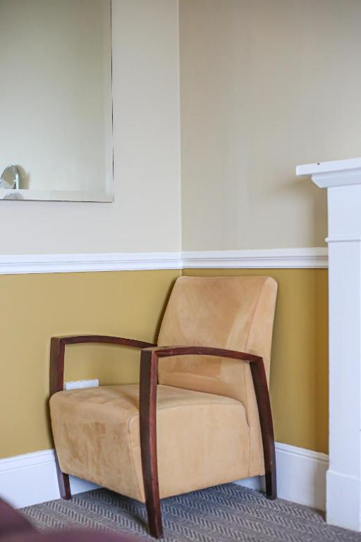 a chair in the corner of a room at The Wellington Hotel in Ventnor