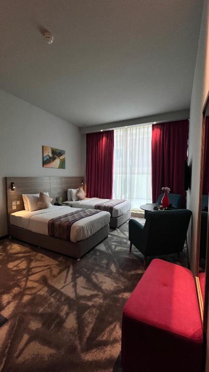 Postel nebo postele na pokoji v ubytování FORTUNE ATRIUM HOTEL