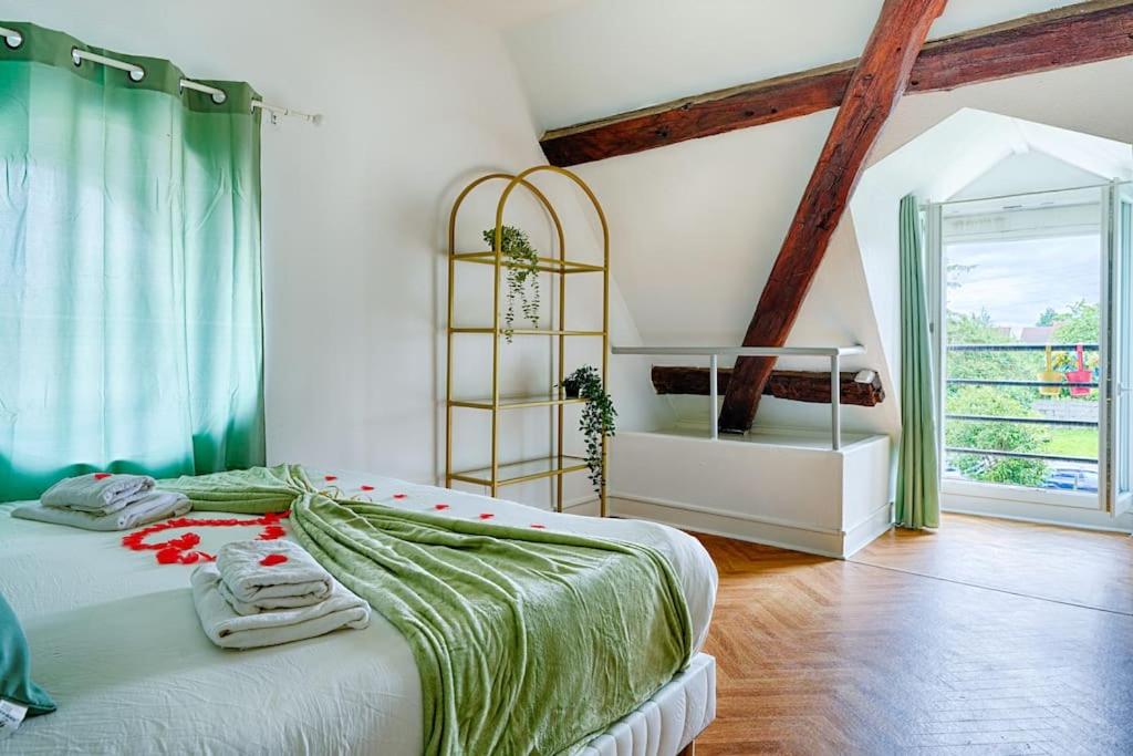 a bedroom with a bed with towels on it at Welcome to Chic Duplex in Wissous