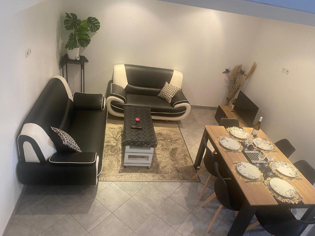 a living room with two chairs and a table at Maison de charme st euphemie in Sainte-Euphémie