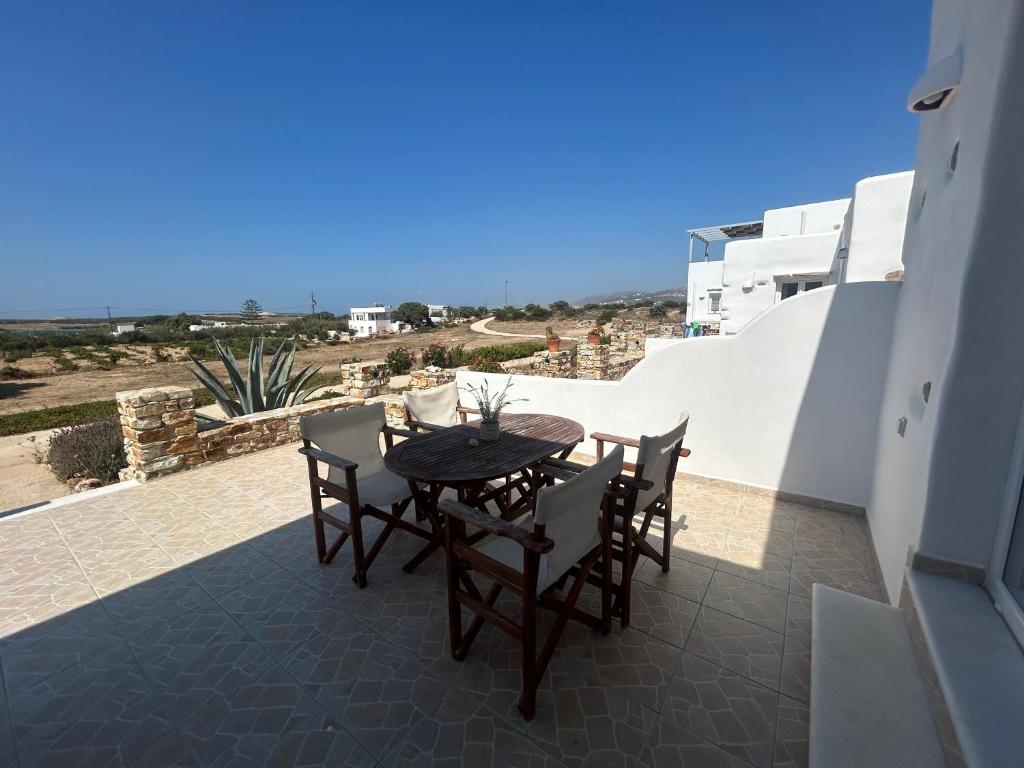 a table and chairs on a balcony with a view at Antiparos Diamond in Antiparos Town
