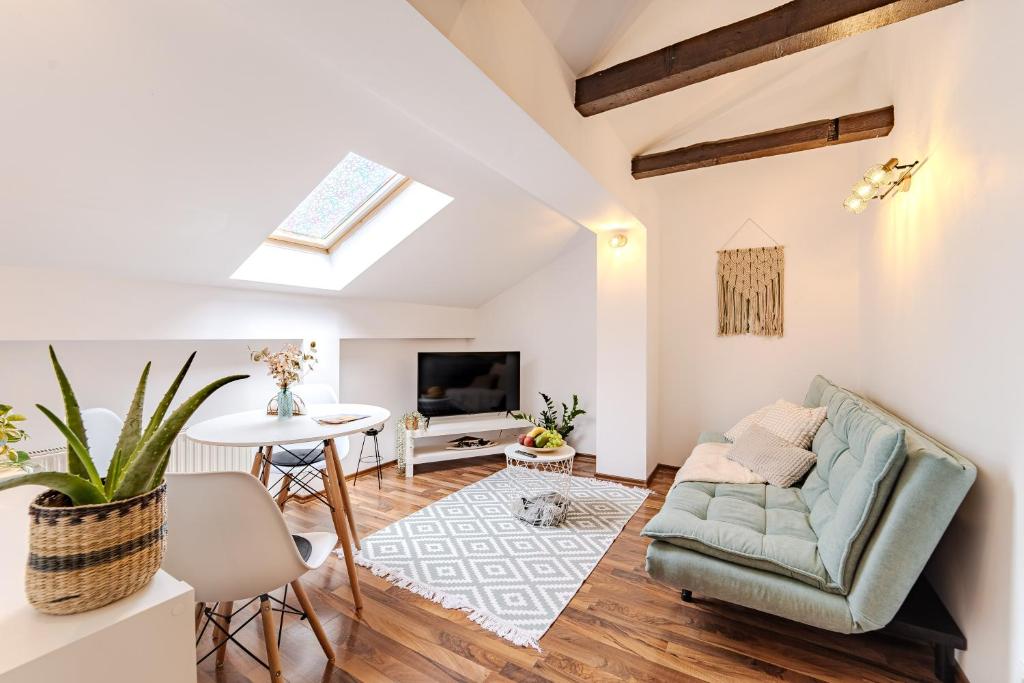 ein Wohnzimmer mit Sofa und Tisch in der Unterkunft Central Pet friendly - Savoya Nordic Loft - By OpenHouse apartments in Timişoara