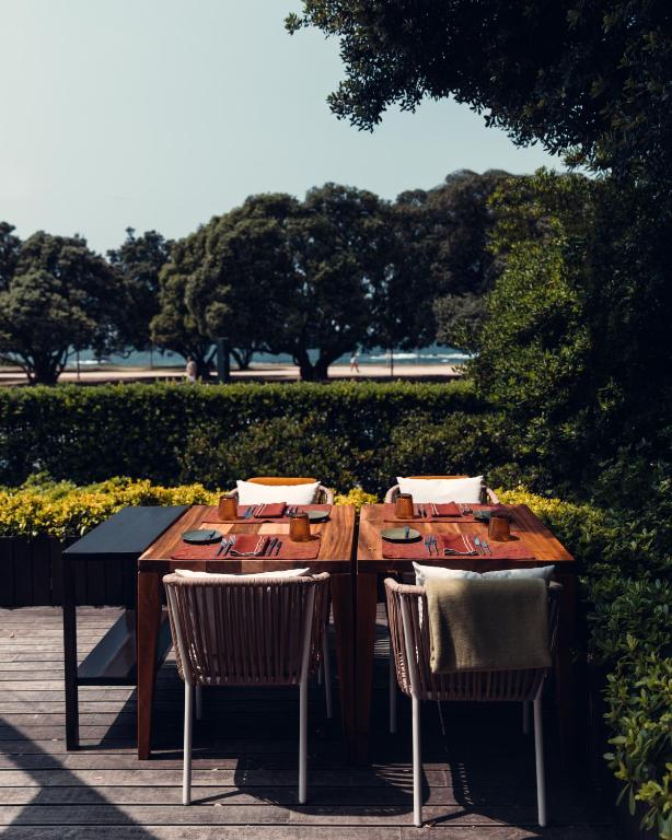 a wooden table with two chairs and sidx sidx sidx at Vila Foz Hotel & SPA - member of Design Hotels in Porto