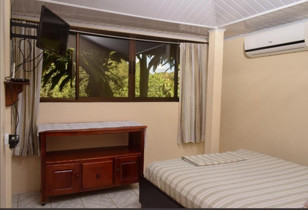 a small bedroom with a bed and a window at Centro Ecológico La Ribera-CABINA 5 in San Rafael