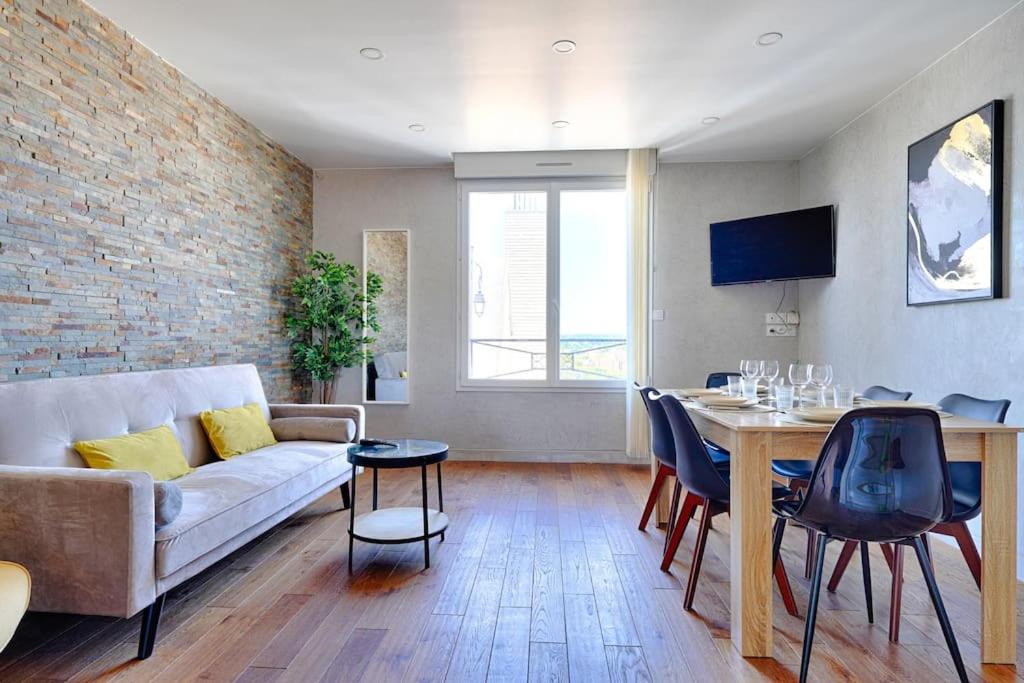 a living room with a couch and a table at Welcome to Stella's House in Montgeron