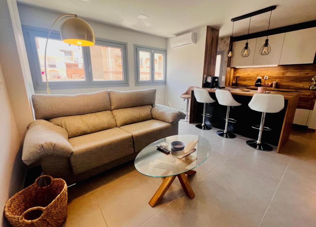 a living room with a couch and a glass table at Rincón de Irene, a 150 mts de Playa del Puerto! in Puerto de Mazarrón
