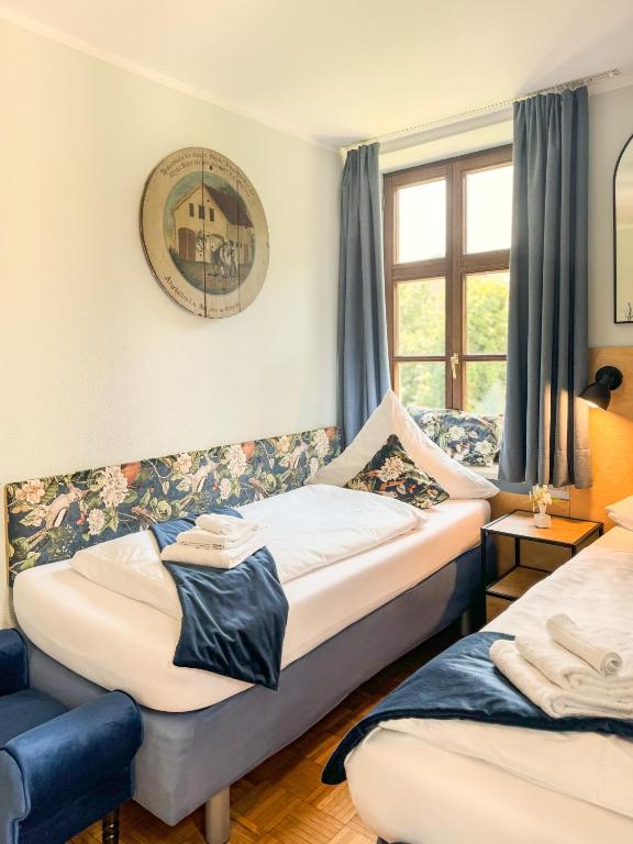 a room with two beds and a window at Villa Fantasia Budget Boutique Hotel in Füssen
