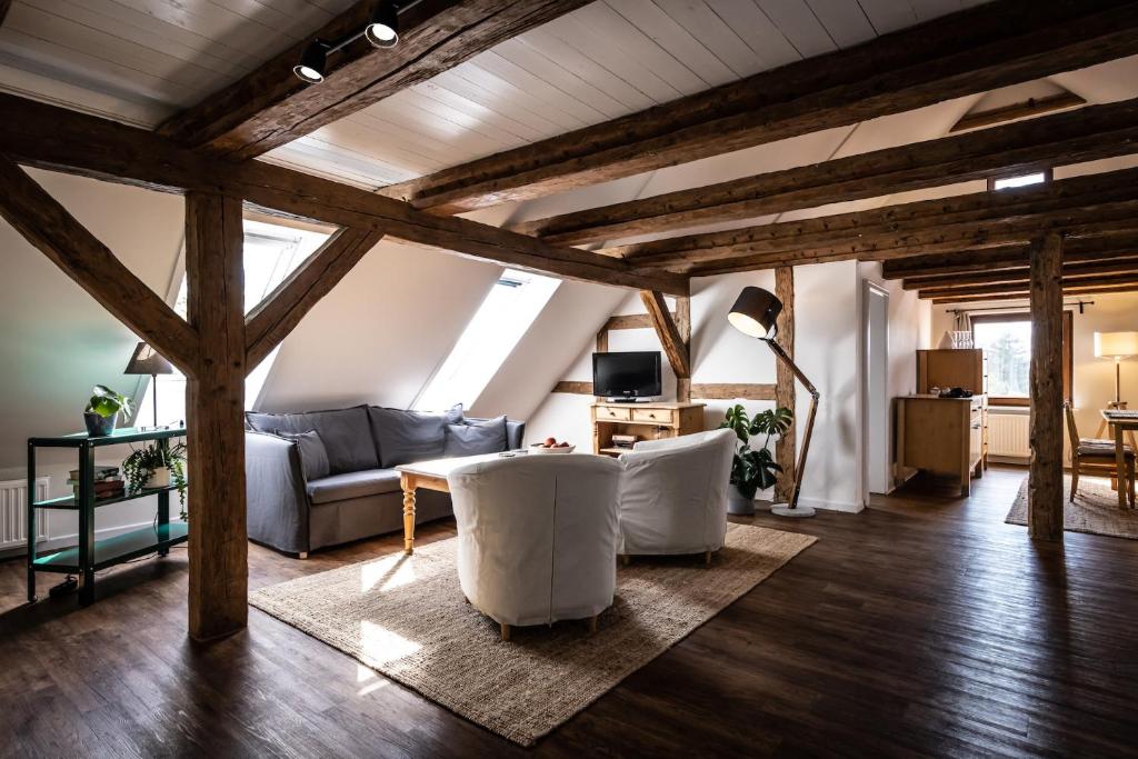 a living room with a couch and a table at GH Maisonette Studio Whg 45 in Bastorf