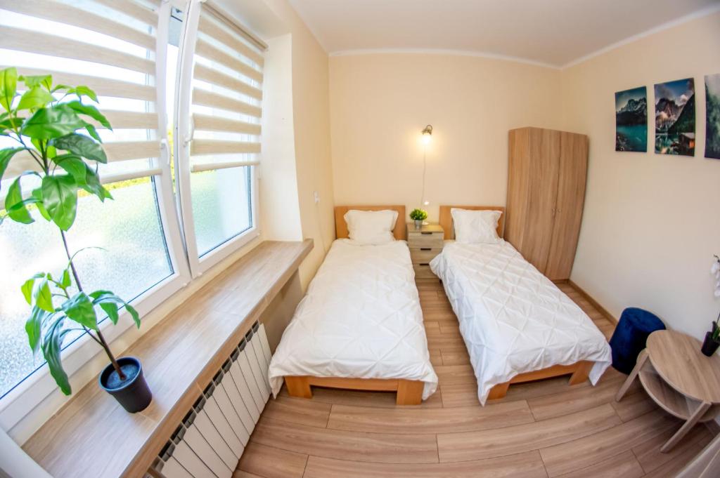 En eller flere senge i et værelse på Kwatery Rydz