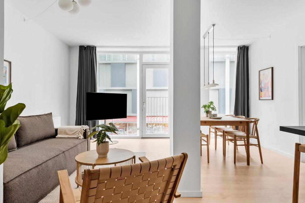 a living room with a couch and a table at Spacious 2BR Inner City Apartment for 6 People in Aarhus
