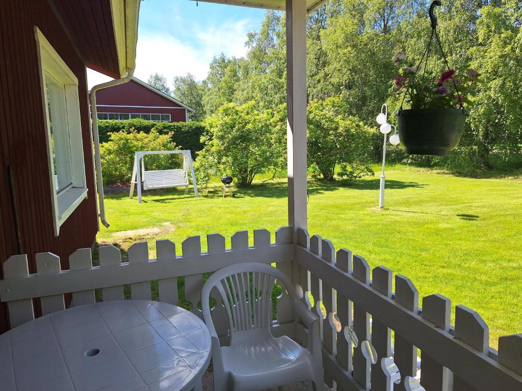 a porch with a white fence and a table and a goal at Sunin Tupa in Rantsila