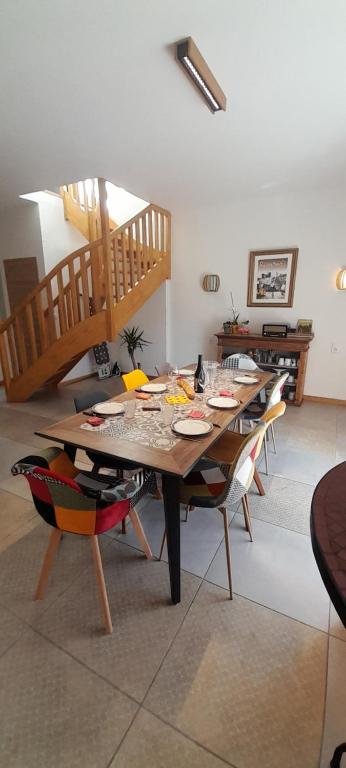 une salle à manger avec une table, des chaises et un escalier dans l'établissement Maison d'hôtes à Saint Rémy Centre, à Saint-Rémy-de-Provence