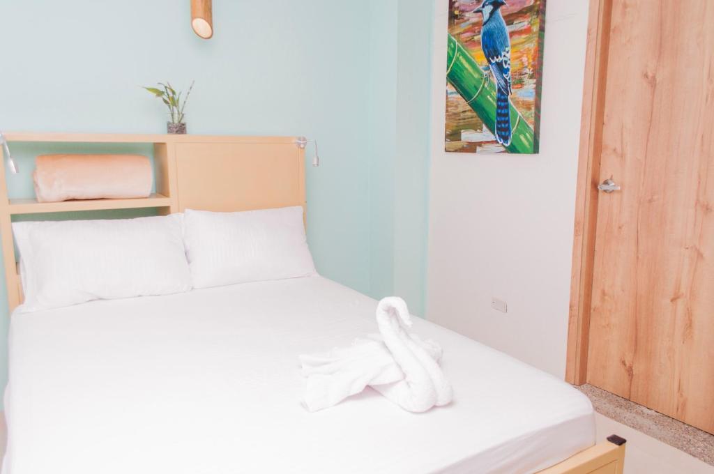 Postel nebo postele na pokoji v ubytování Hostal Las Guaduas