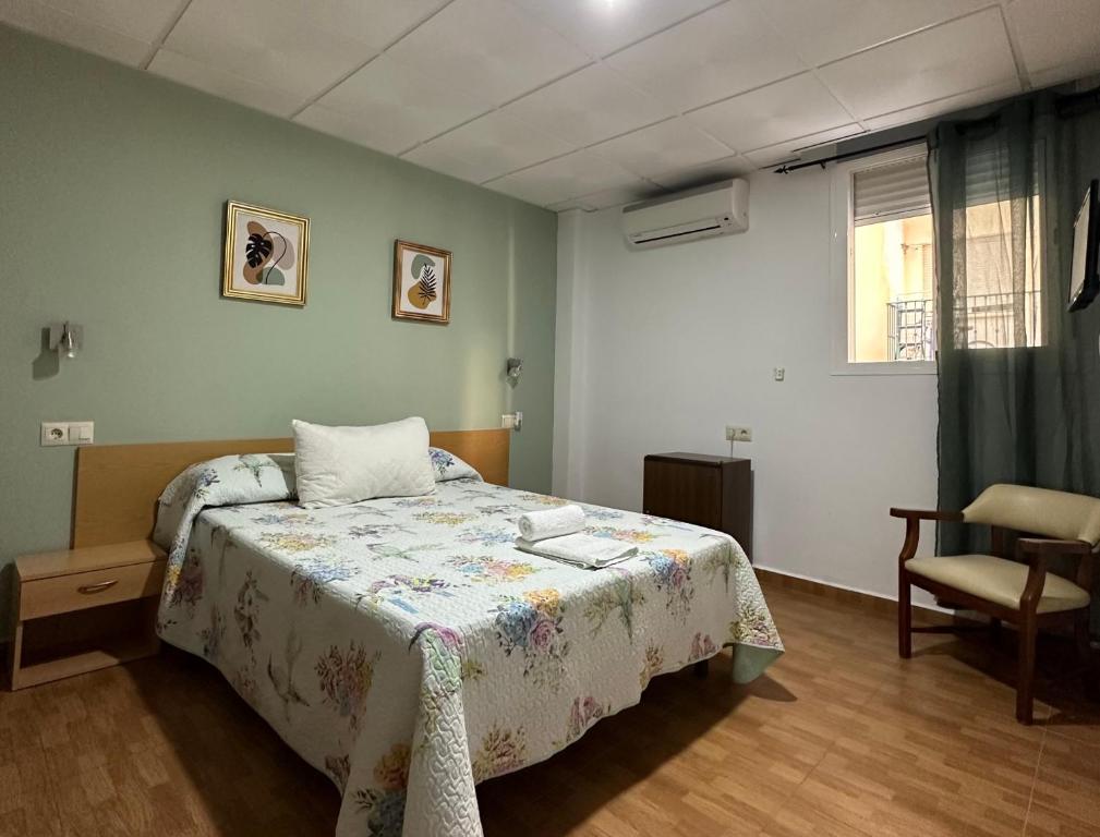 A bed or beds in a room at Hotel Avenida