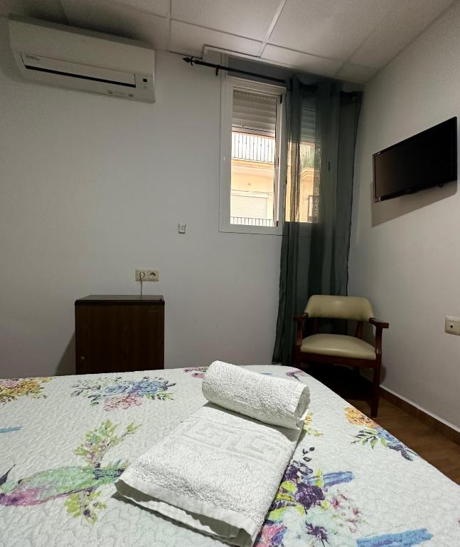 A bed or beds in a room at Hotel Avenida