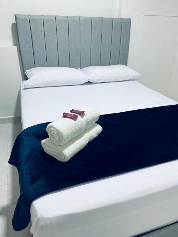 Postel nebo postele na pokoji v ubytování Hotel San Juan 70 Express Medellin