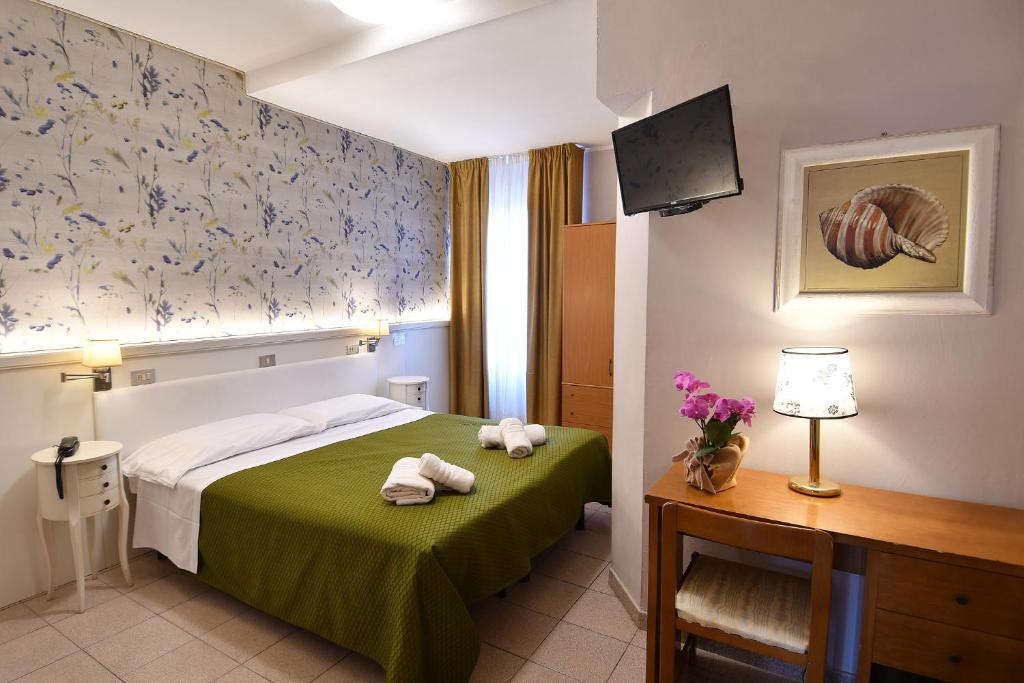 Postel nebo postele na pokoji v ubytování Hotel Innocenti