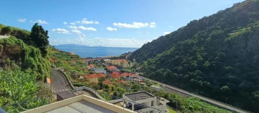 arial view of a town on a mountain with a road at Ribeira Roots Residence in Santa Cruz