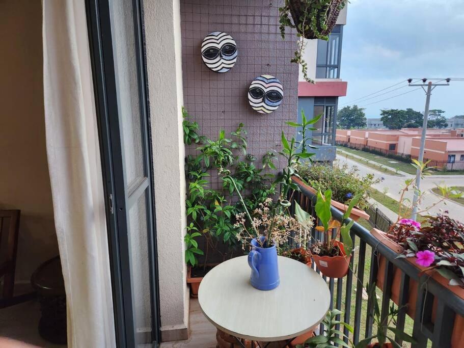 a balcony with a table and masks on a wall at lovely apartment 304 on block D in Wakiso