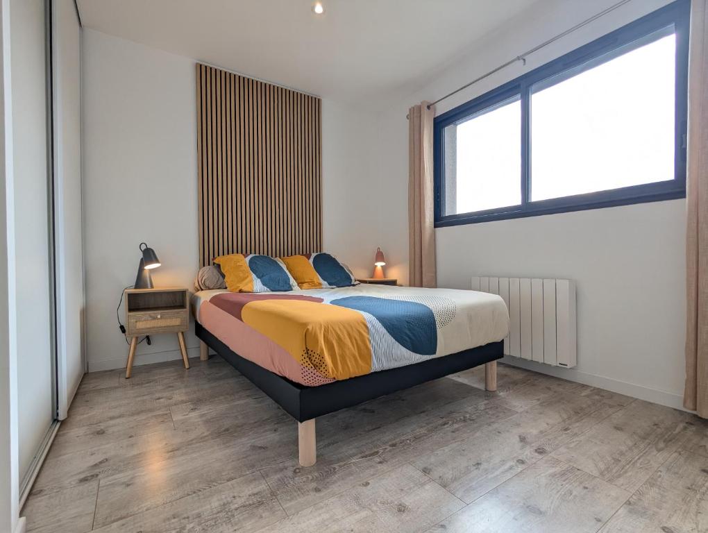 a bedroom with a bed and a large window at Maison TESLA aéroport gare cnpe rte Golf de Lyon in Jons