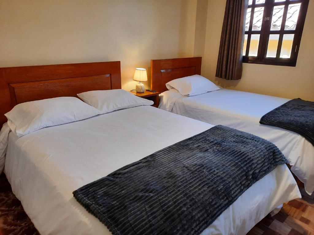 Postel nebo postele na pokoji v ubytování Casa Medina Hostal