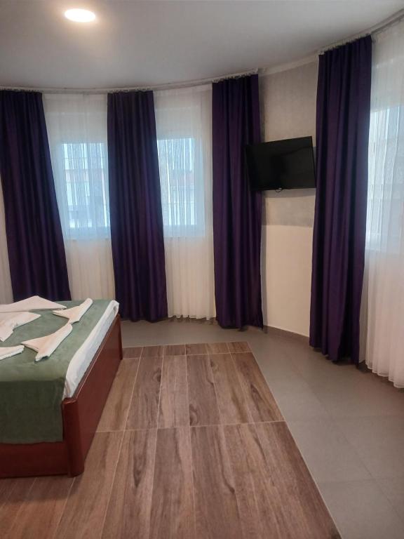 Postel nebo postele na pokoji v ubytování Hotel Denis