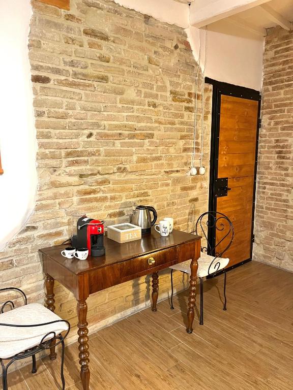 a table in a room with a brick wall at La Casa di Alice in Perugia