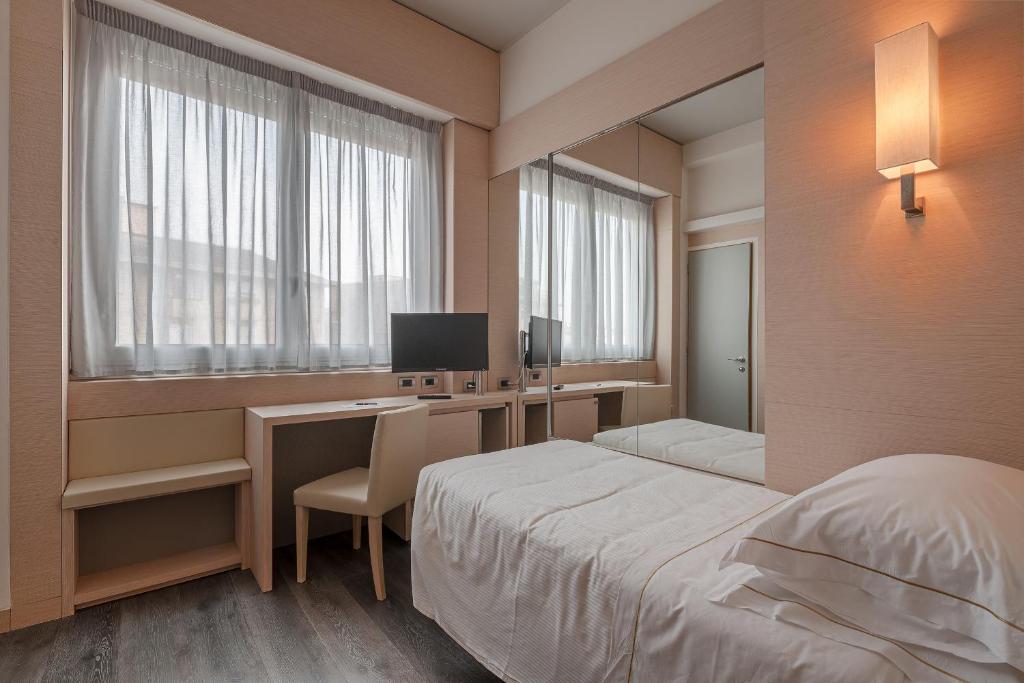 Postel nebo postele na pokoji v ubytování Hotel Ariston
