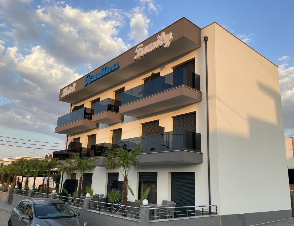 a building with a sign on the side of it at RADINA FAMILY in Kallithea Halkidikis