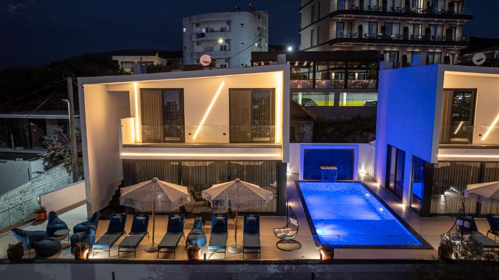 a villa with a swimming pool at night at Luxury Villas Angela in Ksamil