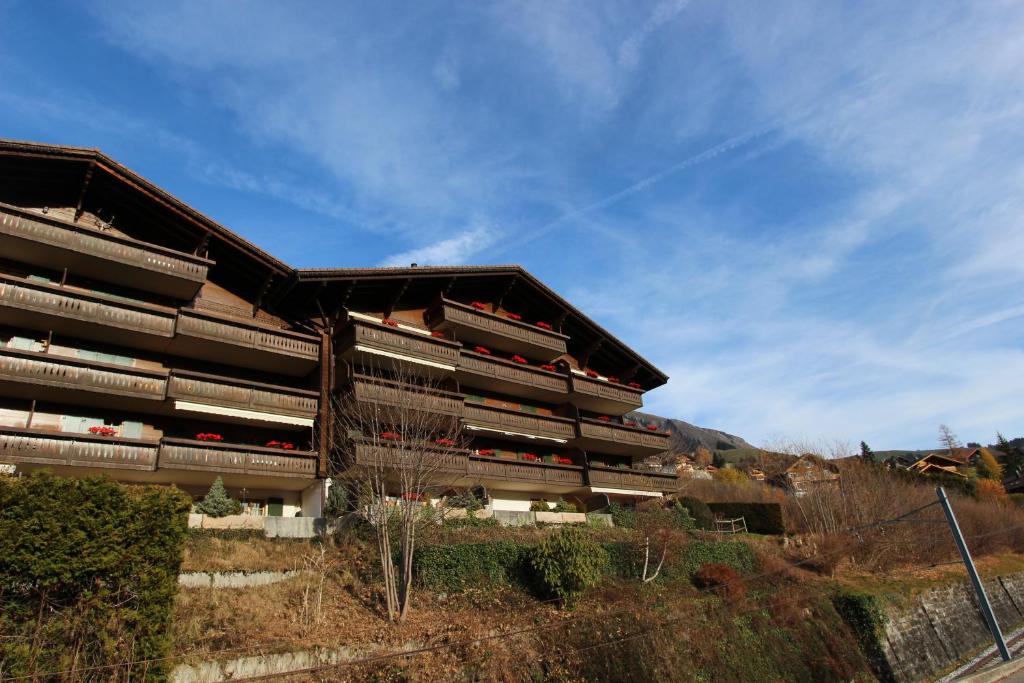 a building on the side of a hill at Forêt C13 in Chateau-d'Oex