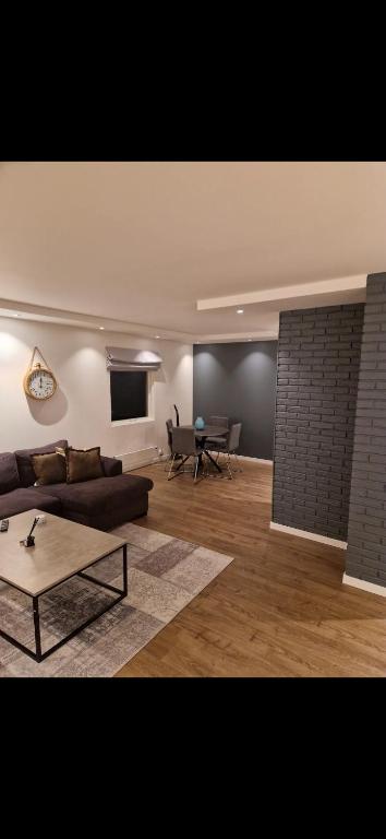 a living room with a couch and a table at Nydelig leilighet til leie in Halden
