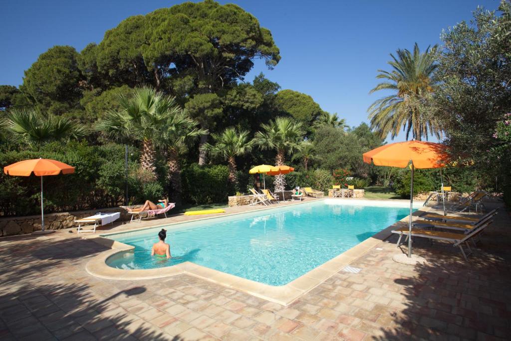 a woman is sitting in a swimming pool at Duca di Castelmonte in Trapani