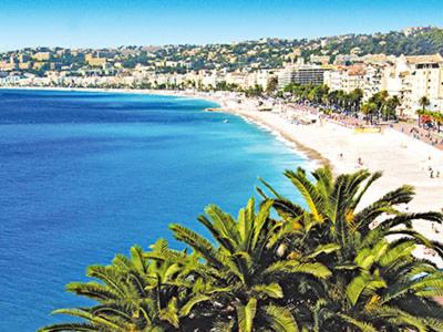 une vue sur une plage avec des palmiers et l'océan dans l'établissement Villa Prestige Soleil & 2 plage, à Nice