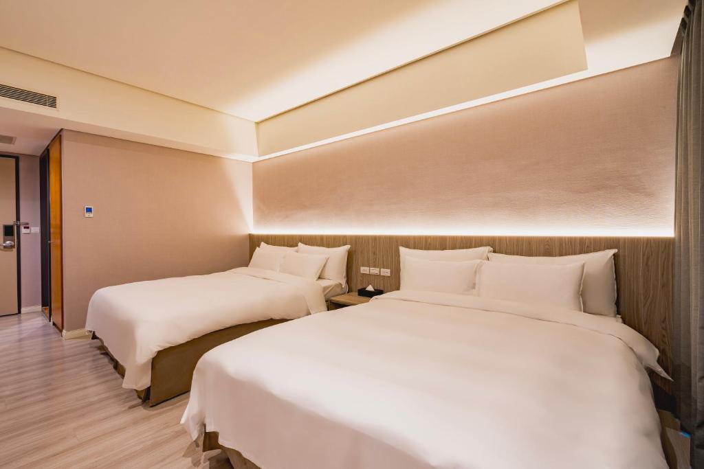 Postel nebo postele na pokoji v ubytování 家美瑞品 台北 - Jiamei Hotel