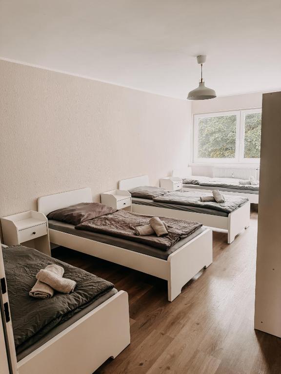 a room with three beds and a window at Wohnen im Ländereck! Essen-Mülheim-Oberhausen! BS2L in Essen