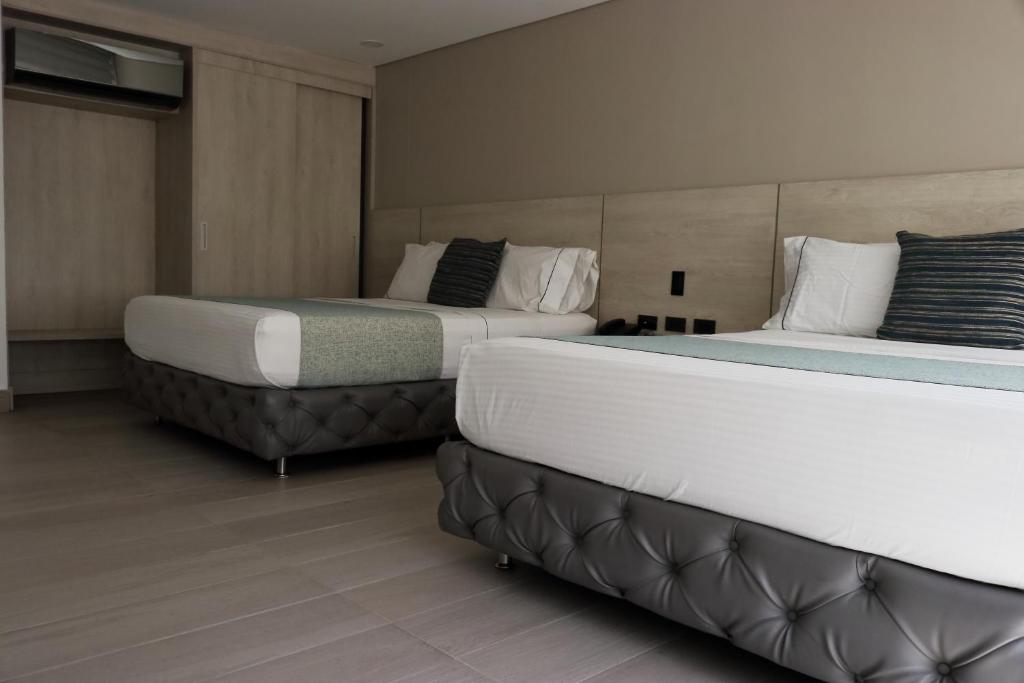 Postel nebo postele na pokoji v ubytování Hotel Loup