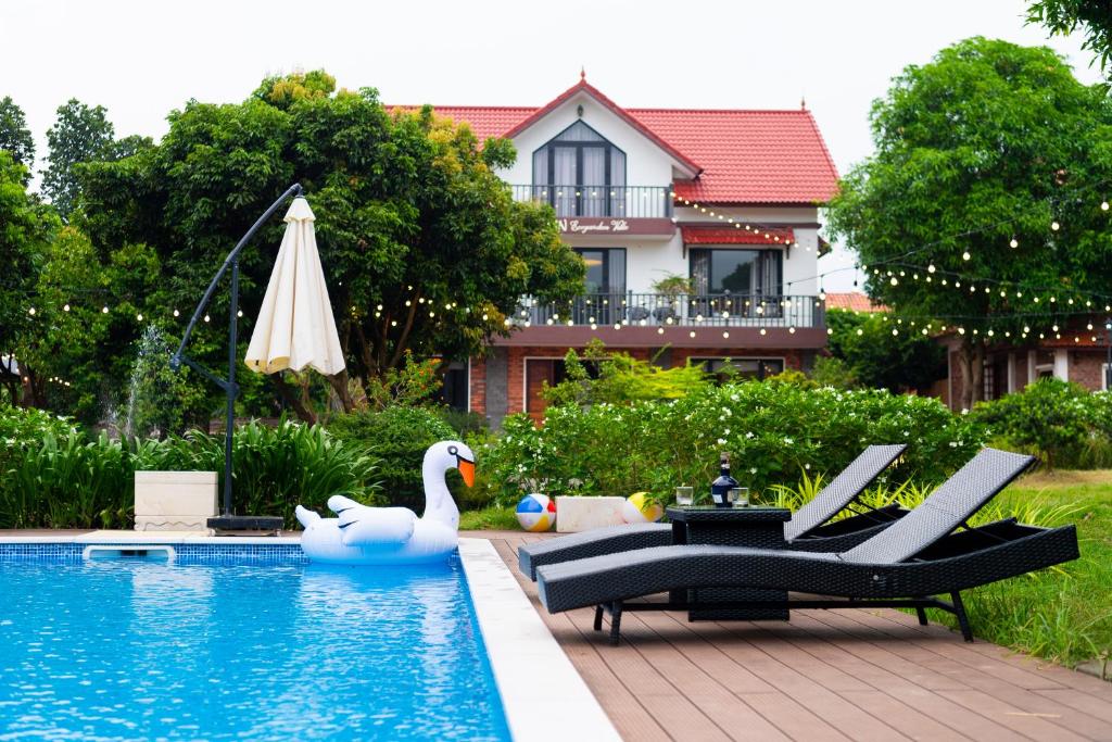 a swimming pool with a swan and a swan float at Green Meadow Villa in Hanoi