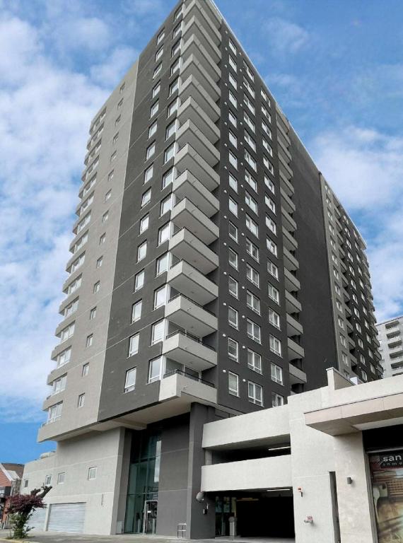 a large gray building with a lot of windows at Montenegro Departamentos in Temuco